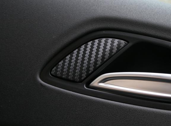 Carbon-look coating for door lock buttons