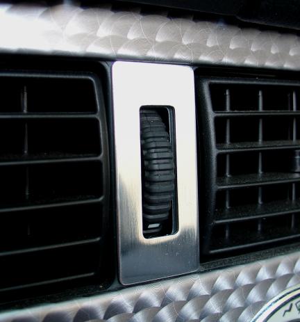 Decorative trim center strip air vent nozzles